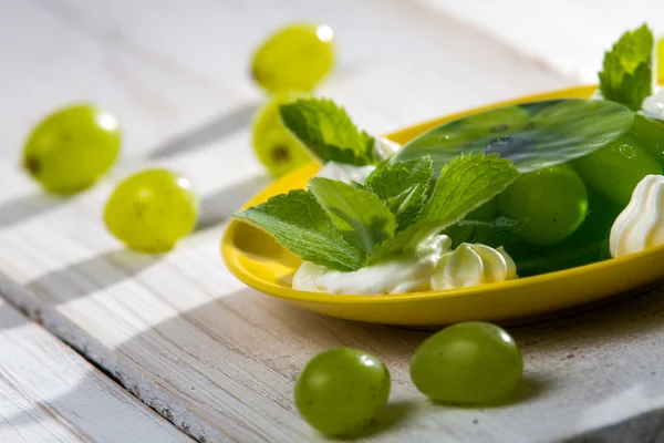 stock image Green grape jelly served with cream