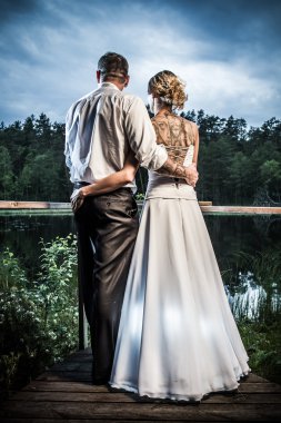 Young couple looking to the storm clouds clipart