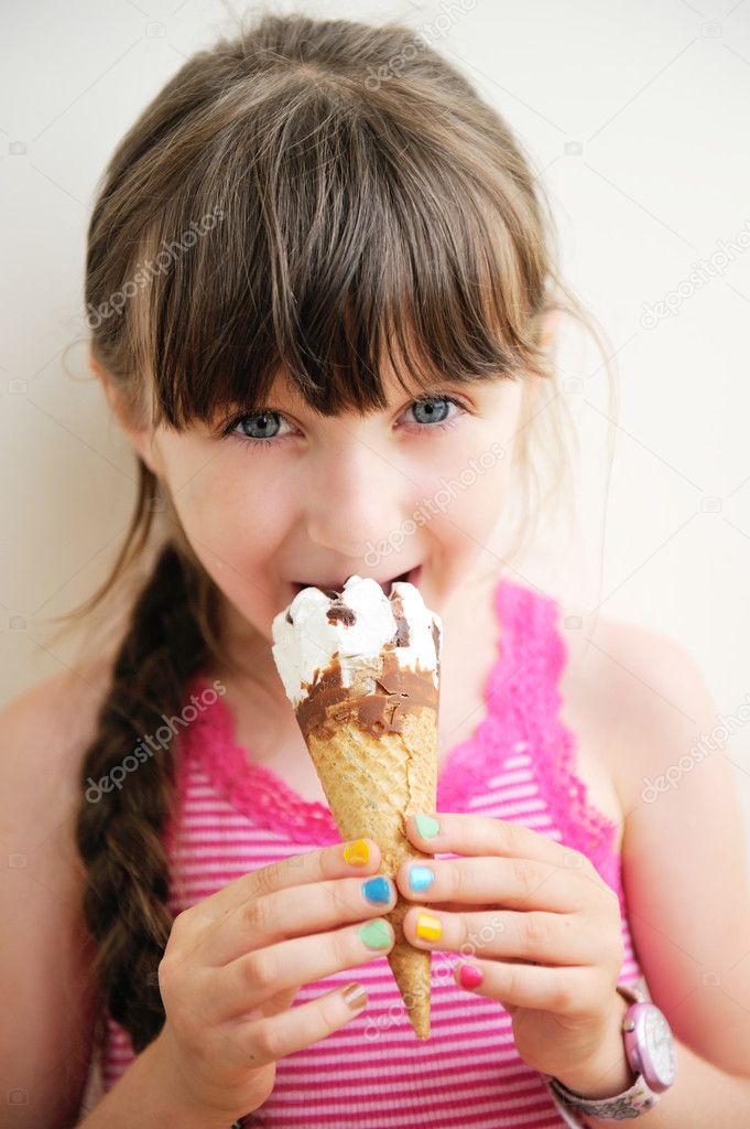 Cute little girl with ice cream in studio