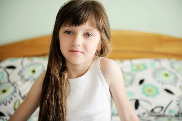 Küçük kız yatakta oturmuş portre uyandırmak — Stok fotoğraf