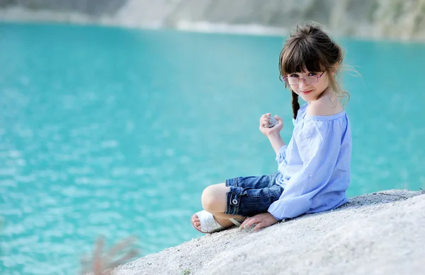 Egy rock ül a kis lány portréja — Stock Fotó