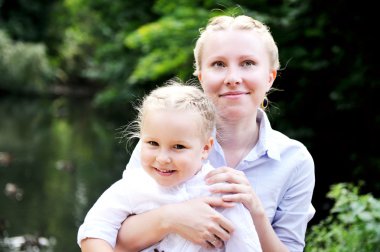 Outdoor portrait of mother and daugter clipart