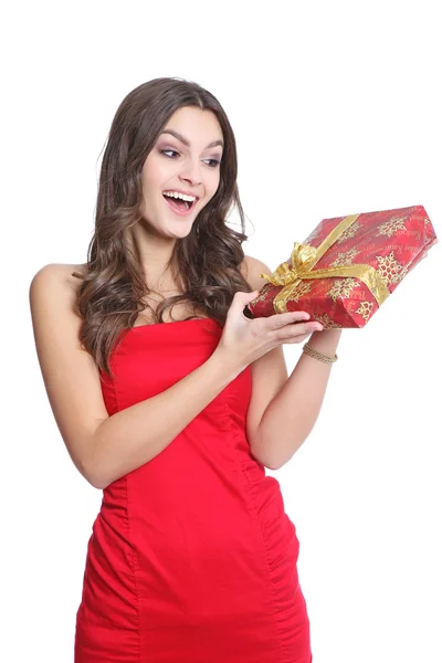 Surprised red dressed girl with a present — Stock Photo, Image