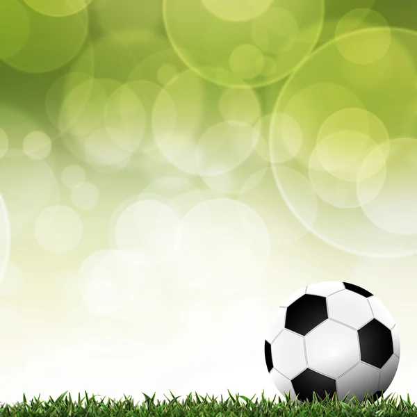 Ποδόσφαιρο στην πράσινη χλόη με φόντο πολύχρωμο — Φωτογραφία Αρχείου