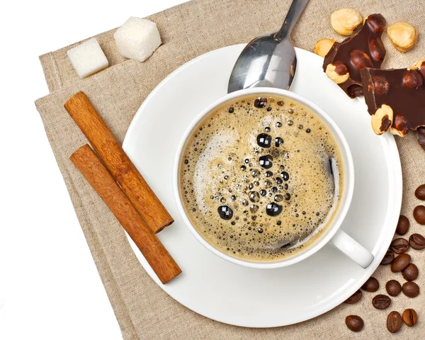 Coffee cup, chocolate, hazelnut, beans, sugar and cinnamon — Stock Photo, Image
