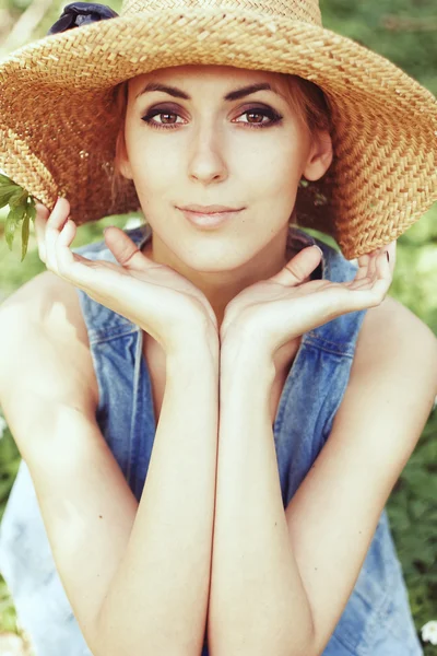 Beautiful girl in hat with white spring flowers — Stock Photo, Image