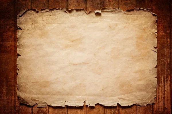 Old paper on wooden board — Stock Photo, Image