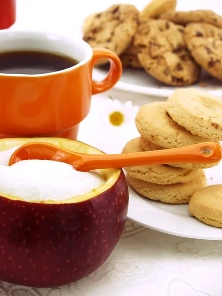 stock image Sugar bowl made of red apple with fructose inside, set on table with coffee and cookies