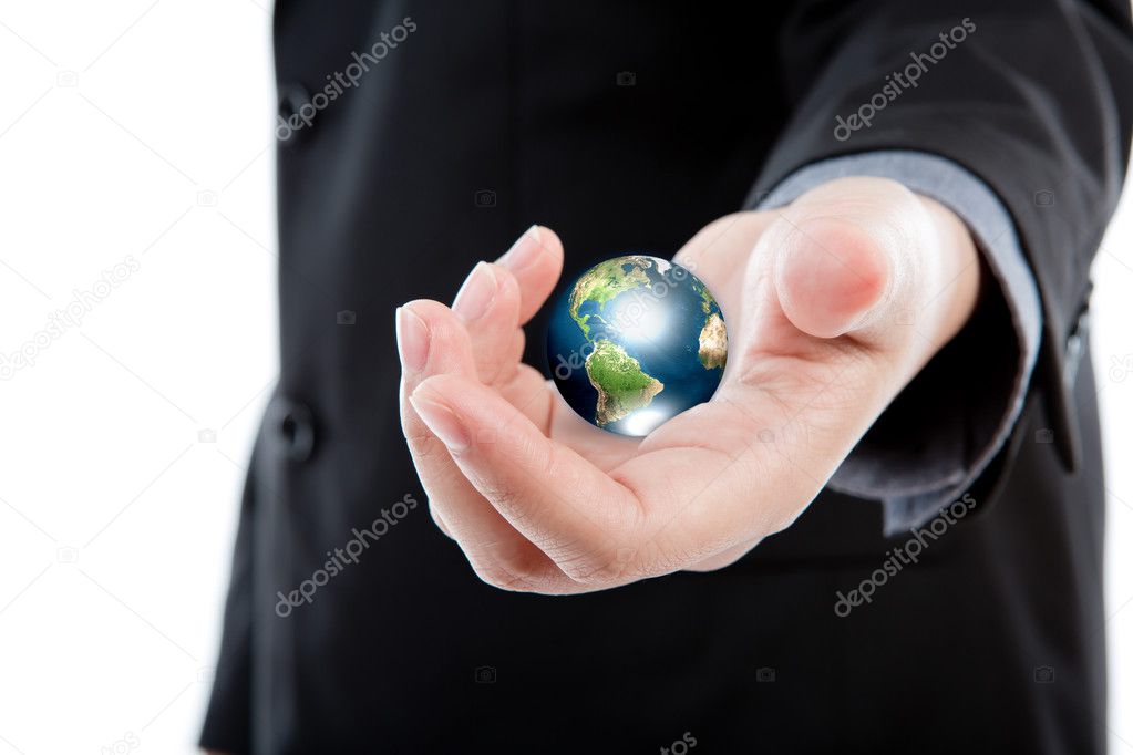 Business man holding the small world in his hands against white