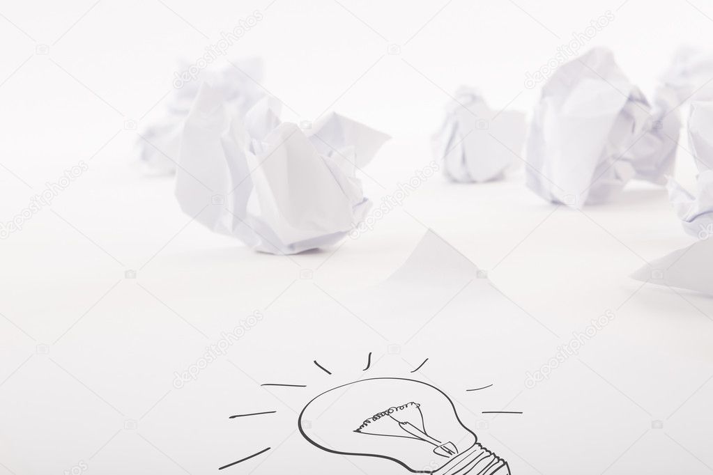 Light bulb write on white paper with Crumpled paper