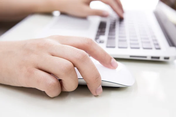 Closeup of business woman hand typing on laptop keyboard with mo Royalty Free Stock Images