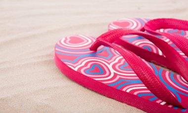 Flipflops on sand beach clipart