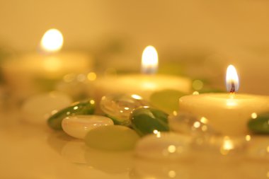 Lit candles surrounded by glass beads clipart