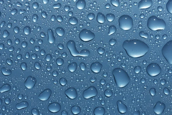 Wassertropfen auf metallisch blau — Stockfoto