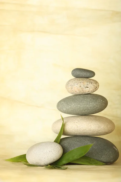 Stacked pebbles & bamboo leaf — Stock Photo, Image