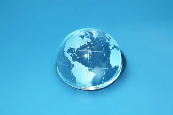 Glass globe in water — Stock Photo, Image