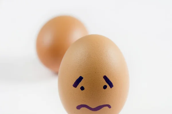 鸡蛋与悲伤的脸 — 图库照片