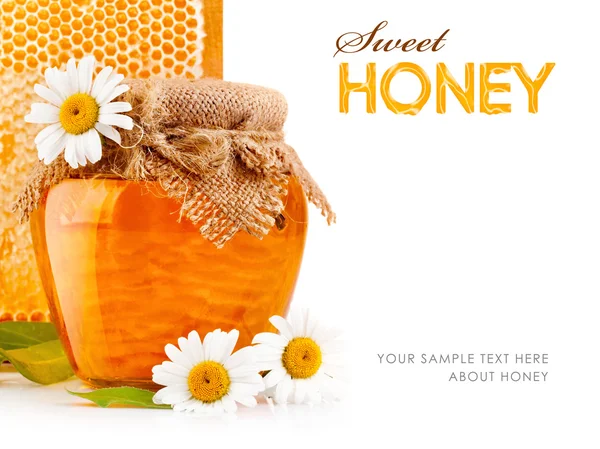 Sweet honey in glass jars with flowers — Stock Photo, Image
