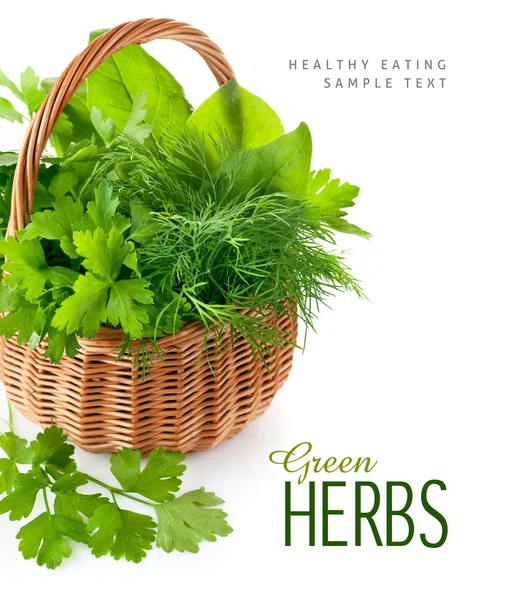 Green herbs in braided basket — Stock Photo, Image