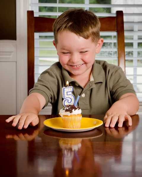 Young boy blowing out his birthday candle — Stock Photo, Image