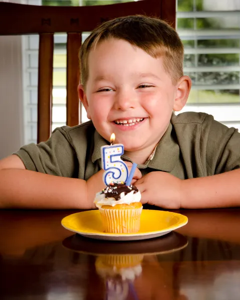 Young boy blowing out his birthday candle — Stock Photo, Image
