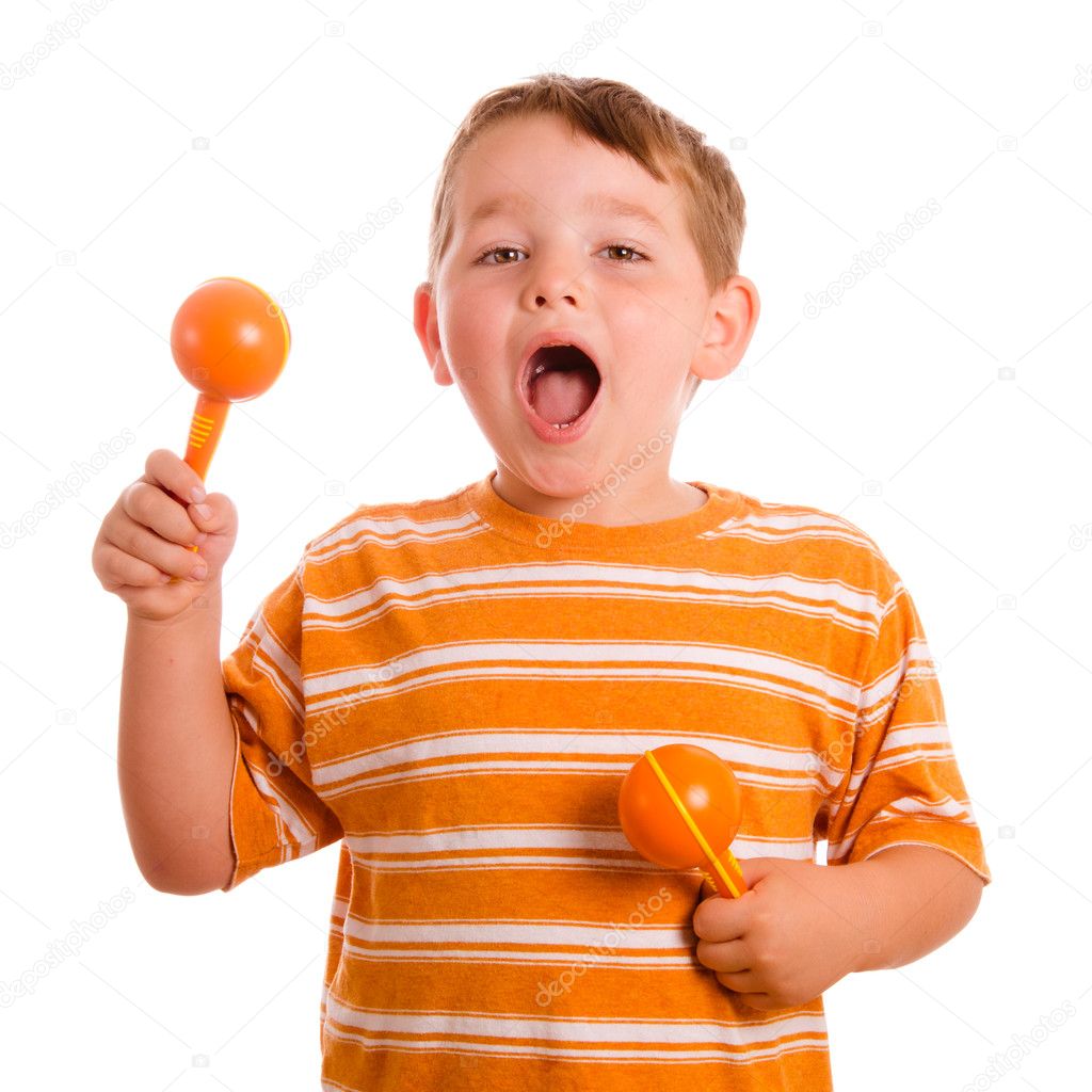 Happy child playing maracas and signing isolated on white