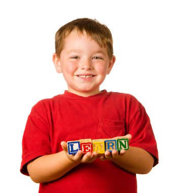 Preschool education concept with child holding blocks that spell out 