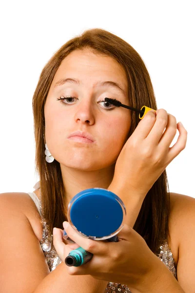 Teenage girl applying makeup or cosmetics isolated on white — Stock Photo, Image