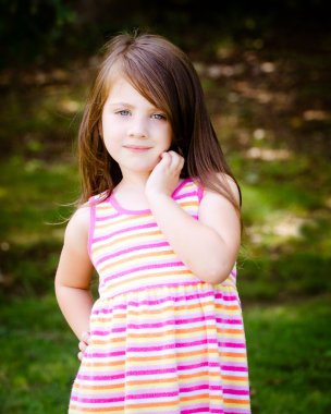 Outdoor portrait of cute young girl in park