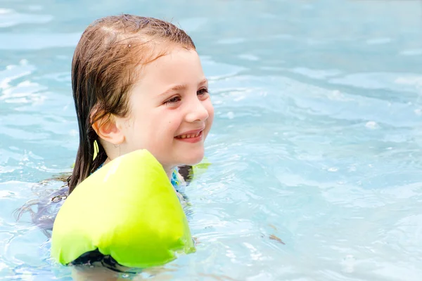 Young girl swimming in pool during hot day in summer Royalty Free Stock Images