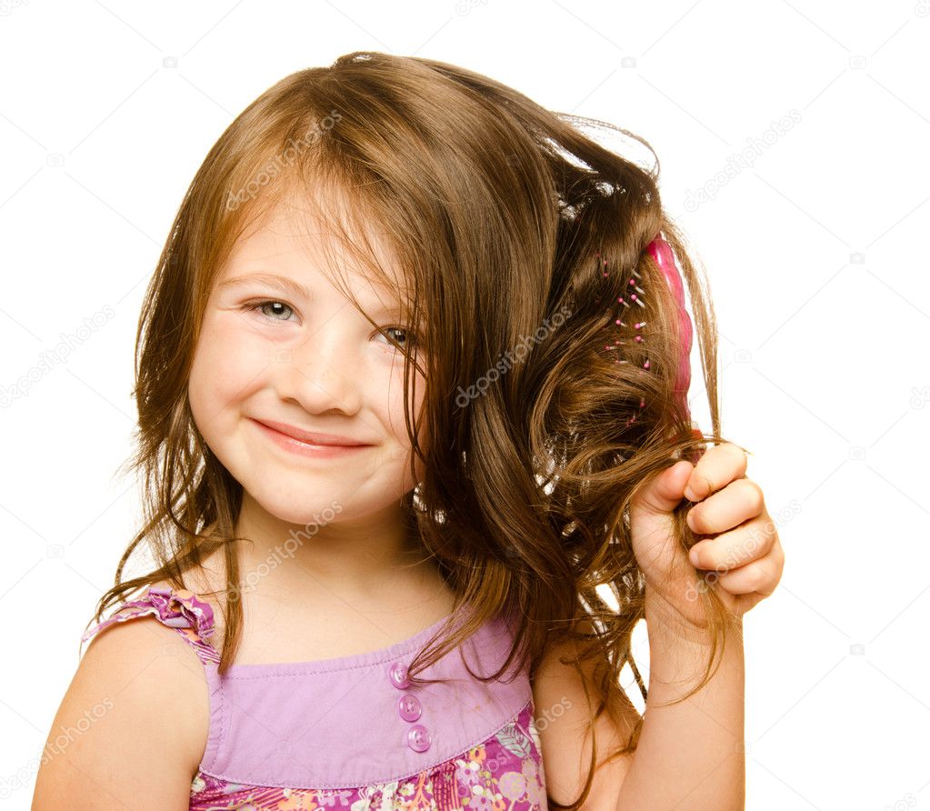 Hair care concept with portrait of girl brushing her unruly, tangled long hair isolated on white