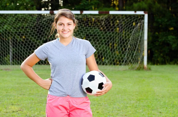 Portrait of teen girl soccer player on field — Stock Fotó