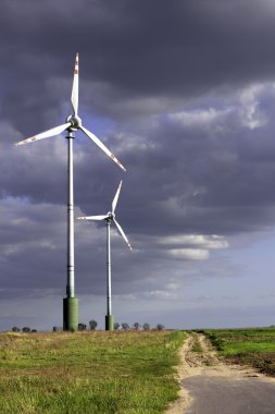 Wind farm on the stormy sky clipart