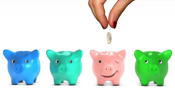 Woman's hand choosing a piggy bank and giving it a piece of money — Stockfoto