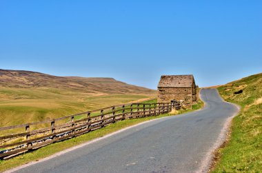 Country road and old stone barn clipart