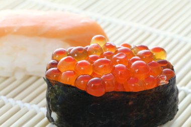 Salmon egg on sushi nigiri roll clipart