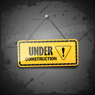 Under construction sign hanging with chain on grunge background clipart