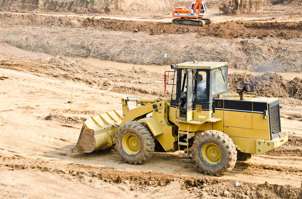 Heavy excavator loader at soil