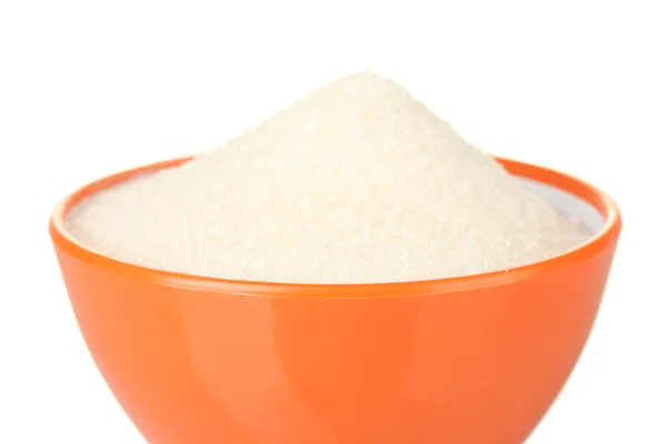 Un colorido tazón lleno de azúcar blanca sobre fondo blanco de cerca — Foto de Stock