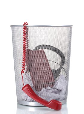 Red phone,headphones and paper in metal trash bin isolated on white clipart