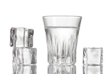 Glass of vodka with ice isolaled on white clipart