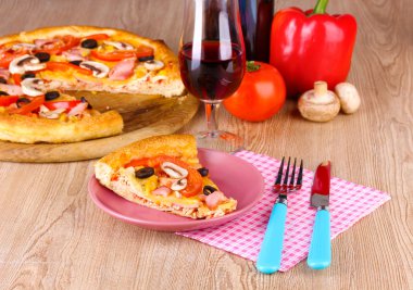 Composition with slice of pizza on plate close-up on wooden background