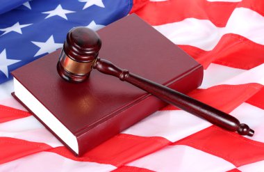 Judge gavel and book on american flag background clipart