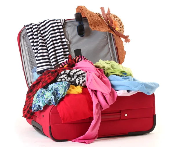 Open red suitcase with clothing isolated on white — Stock Photo, Image