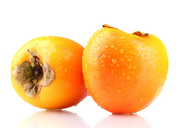 Två aptitretande sharonfrukt med droppar isolerad på vit — Stockfoto
