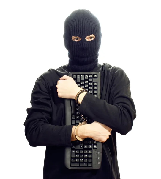 Hacker in black mask in handcuffs with keyboard isolated on white — Stock Photo, Image