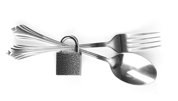 Garfo e colher com cadeado isolado em branco — Fotografia de Stock