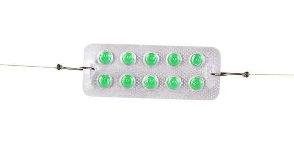 Tablets on fish hooks isolated on white — Stock Photo, Image