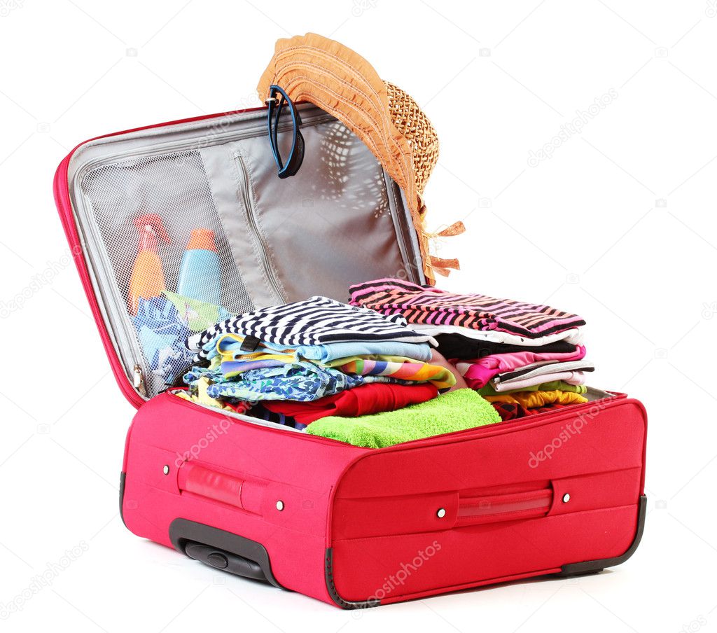 Open red suitcase with clothing isolated on white