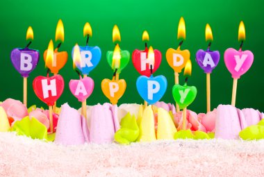 Birthday cake with candles on green background clipart